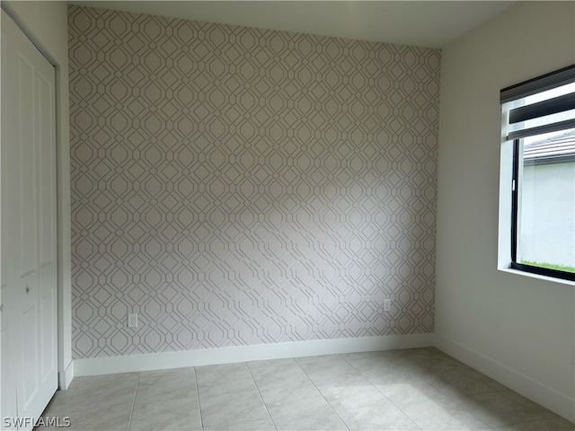 unfurnished room with tile floors