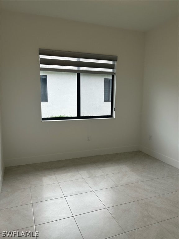 unfurnished room featuring light tile floors