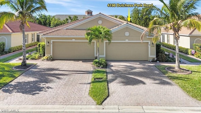 mediterranean / spanish-style home with a garage