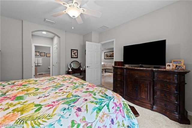 carpeted bedroom with ceiling fan and ensuite bathroom