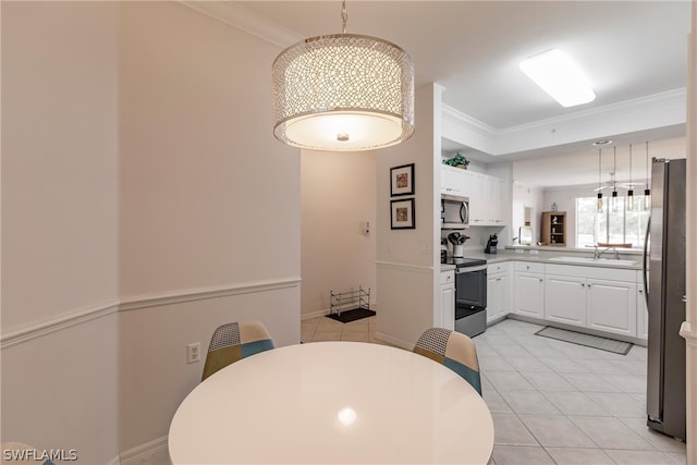 dining space featuring crown molding, sink, and light tile floors