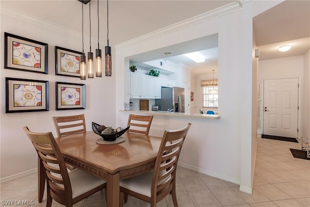 dining room with crown molding and light tile flooring