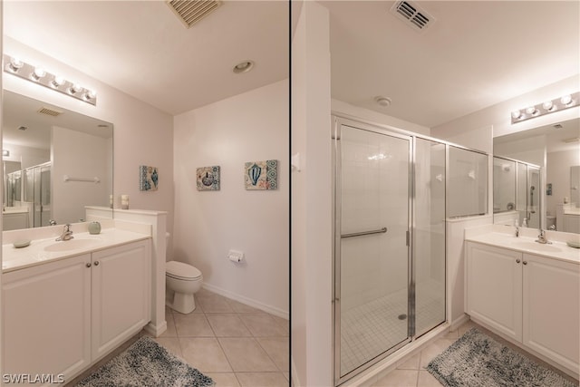 bathroom with tile flooring, toilet, vanity, and walk in shower