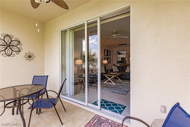 exterior space with ceiling fan and a patio