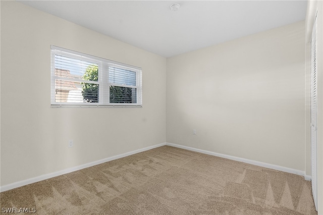 unfurnished room with light colored carpet