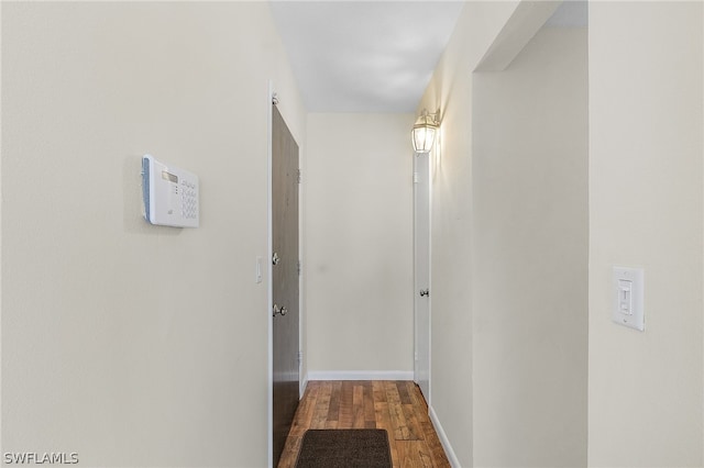 corridor with dark hardwood / wood-style floors