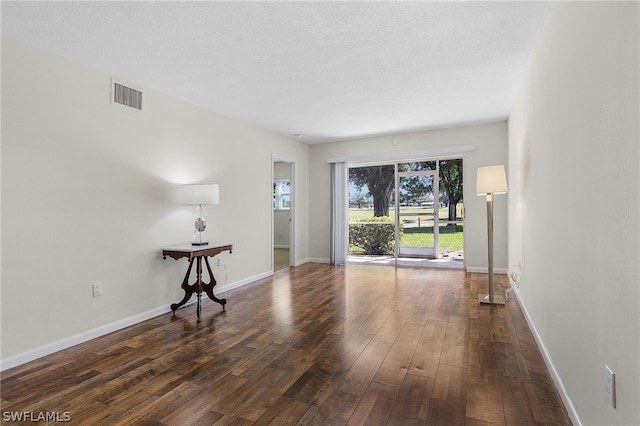 empty room featuring dark hardwood / wood-style flooring