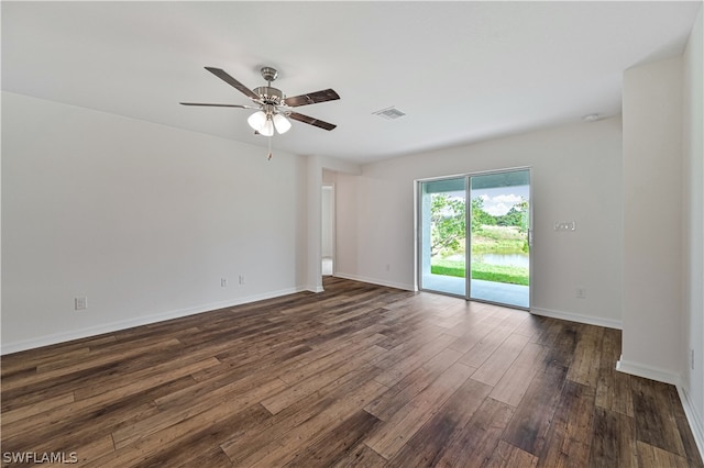 spare room featuring dark hardwood / wood-style floors and ceiling fan