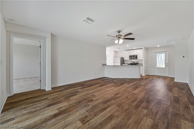 unfurnished living room with dark wood-type flooring and ceiling fan