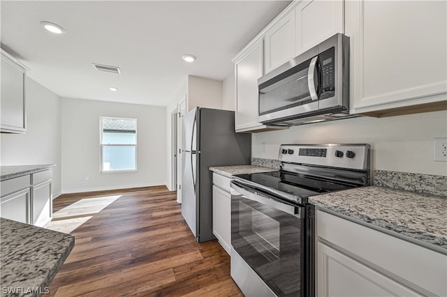 kitchen featuring light stone counters, appliances with stainless steel finishes, white cabinetry, and dark hardwood / wood-style floors