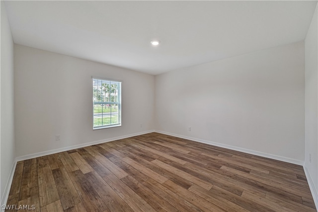 spare room with wood-type flooring