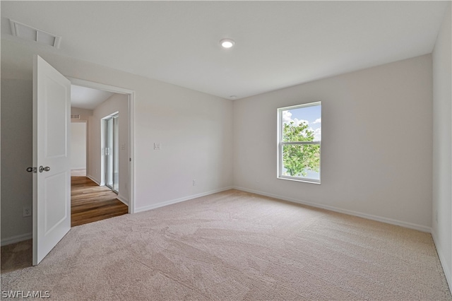 empty room with hardwood / wood-style floors