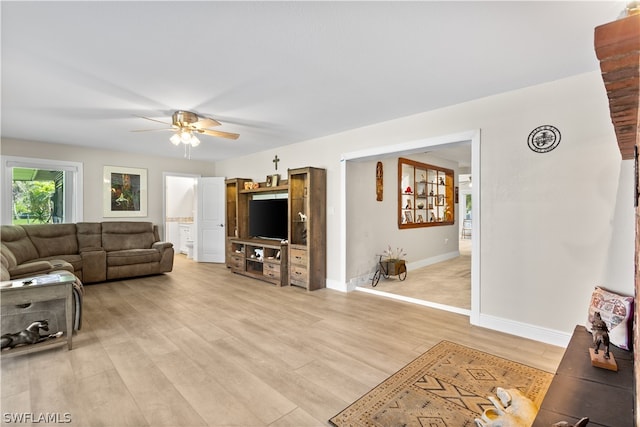 living room with ceiling fan and light hardwood / wood-style floors