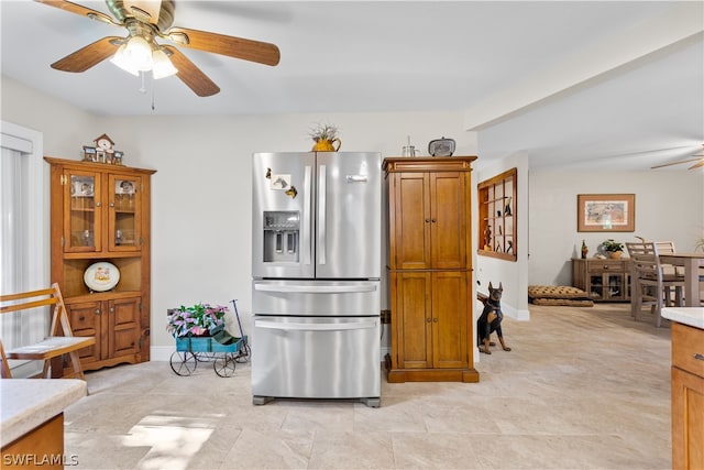 kitchen featuring ceiling fan, stainless steel fridge, and light tile floors