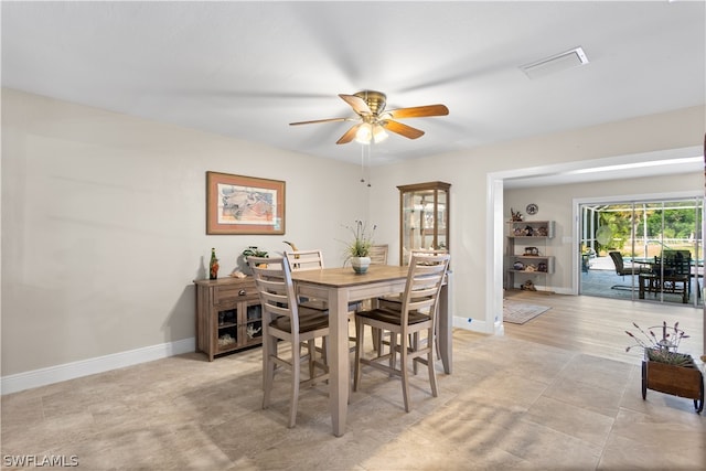 dining area with ceiling fan and light tile floors