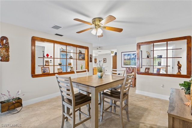 dining space with ceiling fan and light tile floors