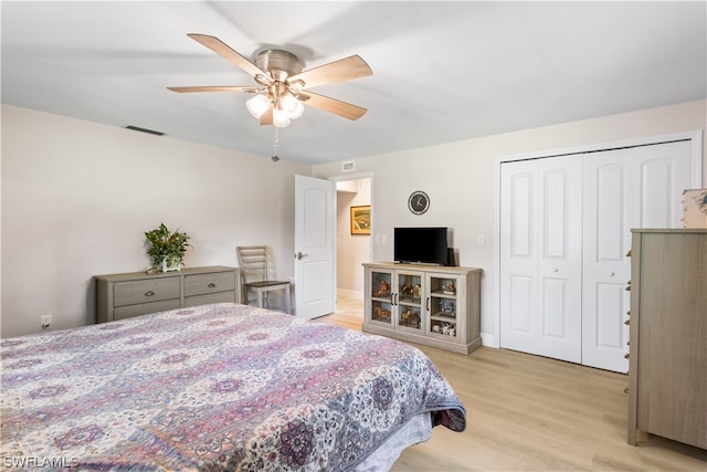 bedroom with a closet, ceiling fan, and light wood-type flooring