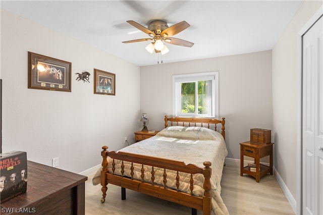 bedroom with a closet, light hardwood / wood-style floors, and ceiling fan