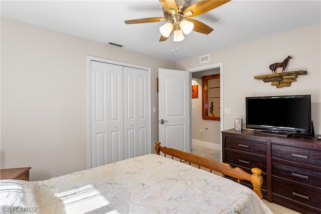 carpeted bedroom with a closet and ceiling fan