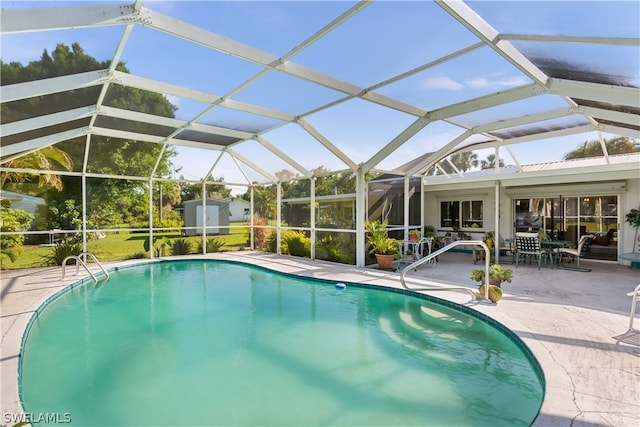 view of pool with a patio and glass enclosure