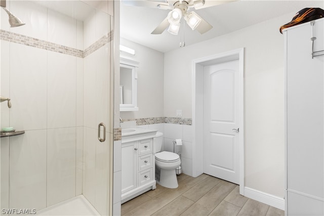 bathroom with an enclosed shower, toilet, ceiling fan, and vanity