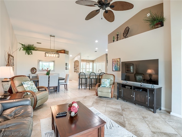 living room with vaulted ceiling, ceiling fan, and light tile flooring