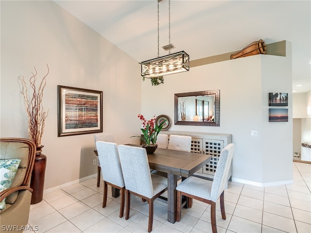 tiled dining area featuring a chandelier