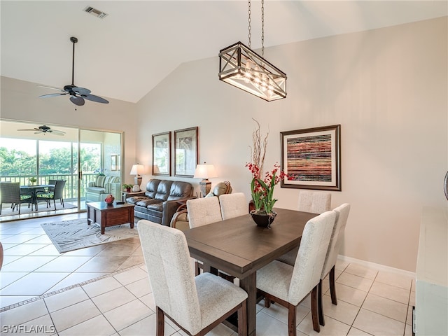 dining space with high vaulted ceiling, ceiling fan, and light tile flooring