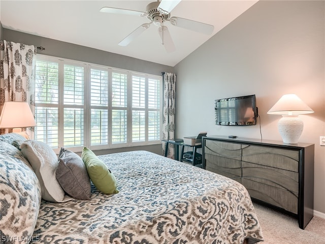 bedroom with lofted ceiling, ceiling fan, and light carpet