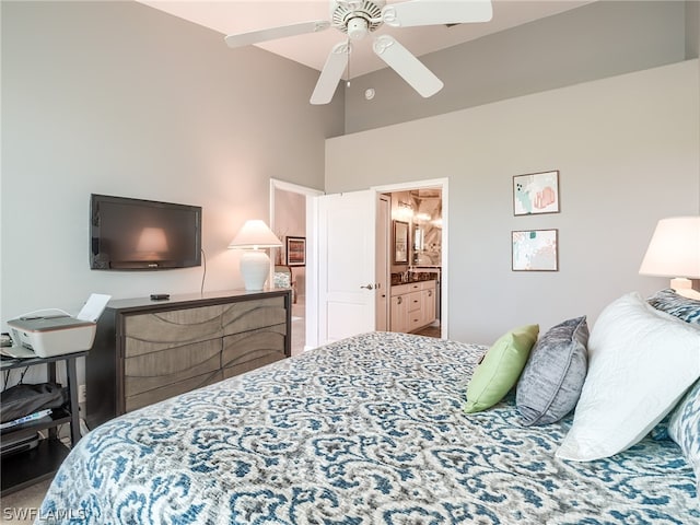 bedroom with ensuite bath, ceiling fan, and a high ceiling