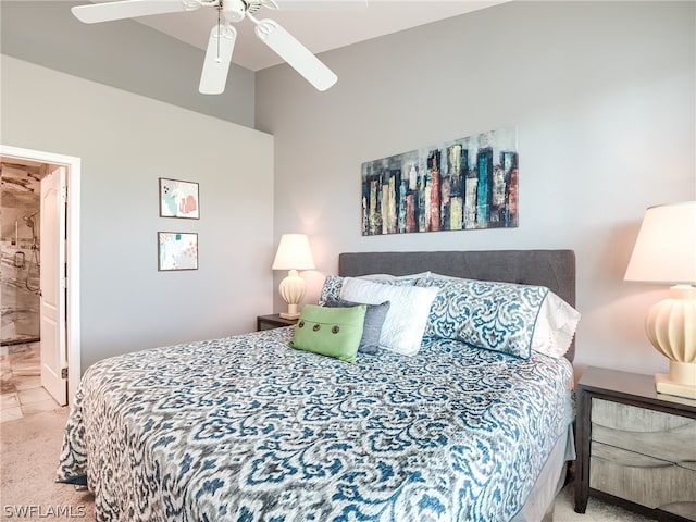 bedroom with light colored carpet, ceiling fan, and ensuite bathroom