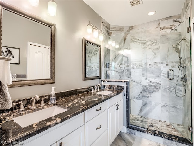 bathroom featuring dual bowl vanity and an enclosed shower