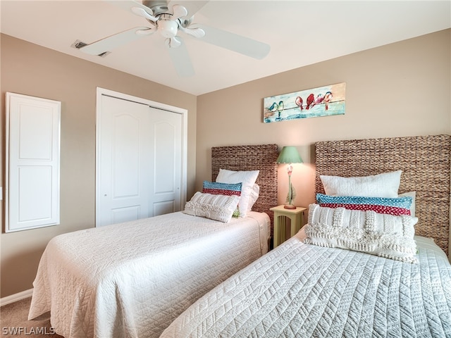 bedroom with carpet flooring, ceiling fan, and a closet