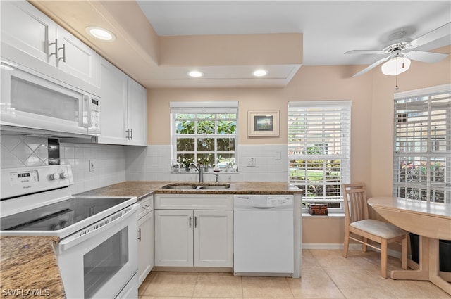 kitchen featuring white cabinets, white appliances, light tile patterned floors, and sink