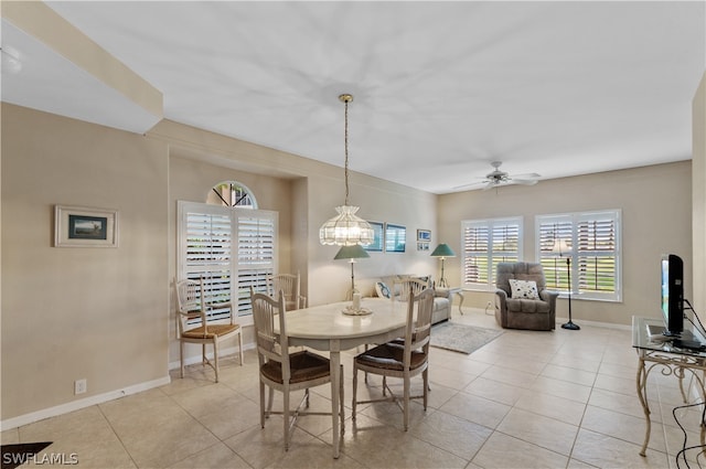 tiled dining area featuring ceiling fan