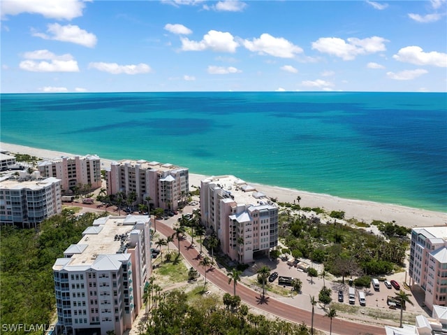 bird's eye view featuring a water view and a beach view