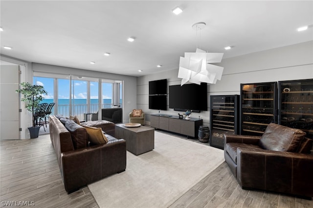 living room with a water view, wine cooler, and light hardwood / wood-style floors