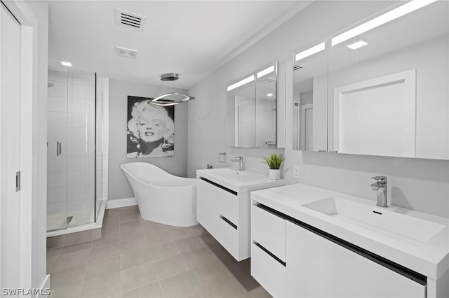 bathroom with a shower with shower door, tile flooring, and vanity