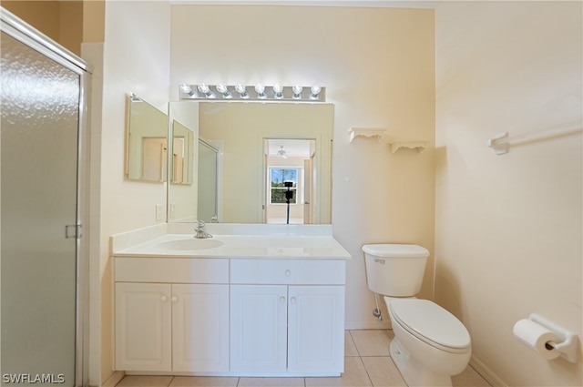 bathroom with toilet, tile floors, and large vanity