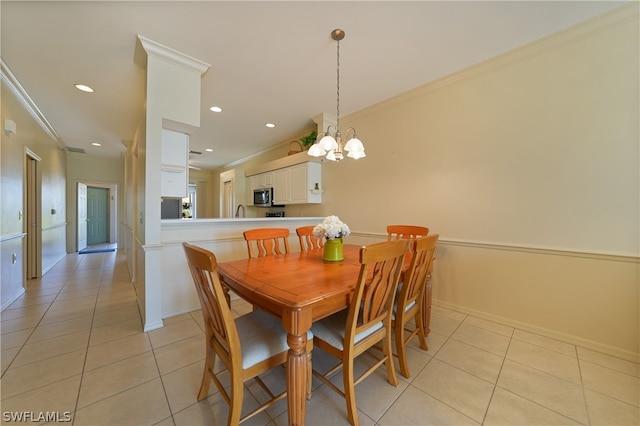 tiled dining space featuring ornamental molding and a notable chandelier