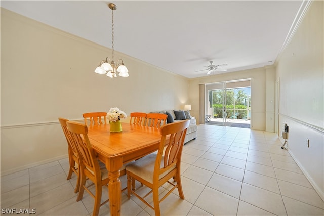 dining room with ceiling fan with notable chandelier, light tile flooring, and ornamental molding