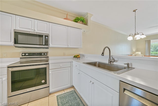 kitchen with stainless steel appliances, white cabinetry, sink, and decorative light fixtures