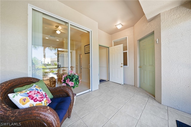 interior space with ceiling fan and light tile floors