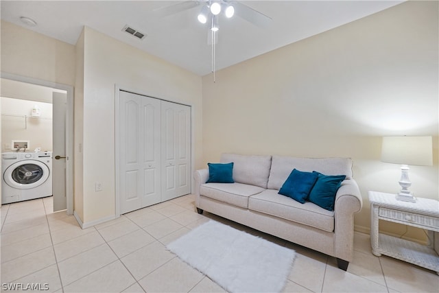 living room with ceiling fan, washer / clothes dryer, and light tile floors