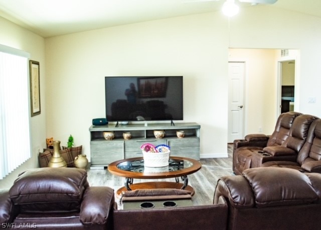 living room with lofted ceiling and hardwood / wood-style flooring