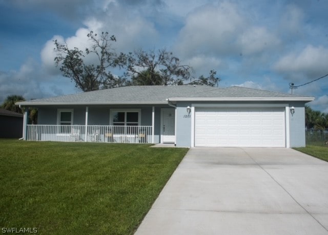 ranch-style home with covered porch, a garage, and a front yard