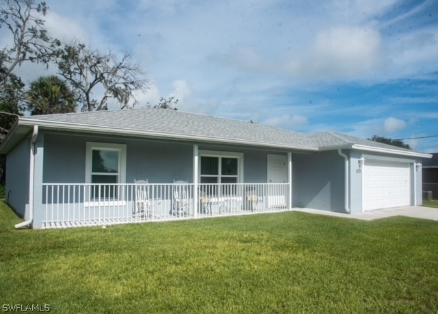 ranch-style home featuring covered porch, a garage, and a front yard