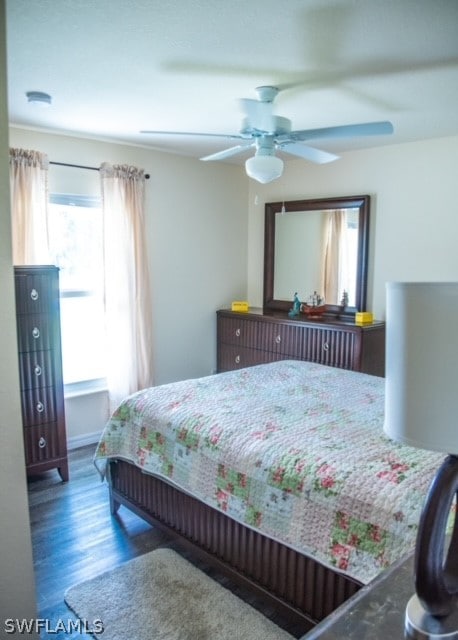 bedroom with ceiling fan and dark wood-type flooring