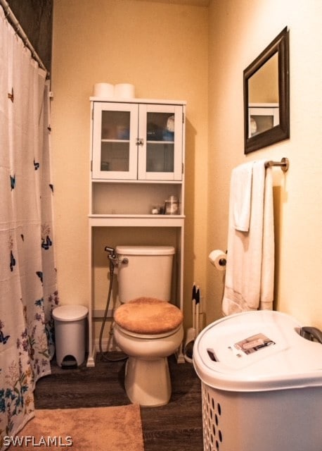 bathroom featuring wood-type flooring and toilet