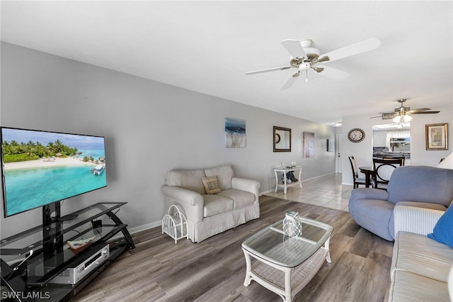 living room with ceiling fan and wood-type flooring